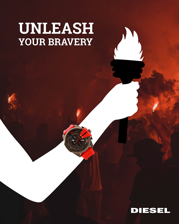 This is the first page of a campaign advertisement for Diesel. The
		tagline at the top left part of the piece says UNLEASH YOUR BRAVERY. a
		white sillouette of a person holding a torch can be seen, as well as the 
		watch being advertised. In the background is a crowd of people holding red
		lights of their own, as well as a lot of smoke.